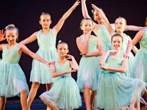 a group of girls in dresses
