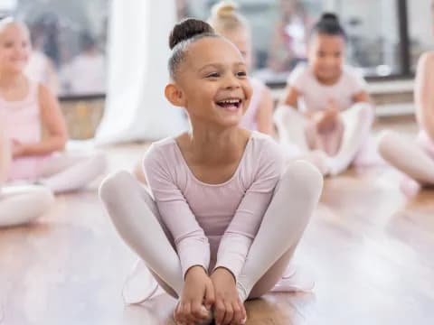 a young girl sitting on the floor