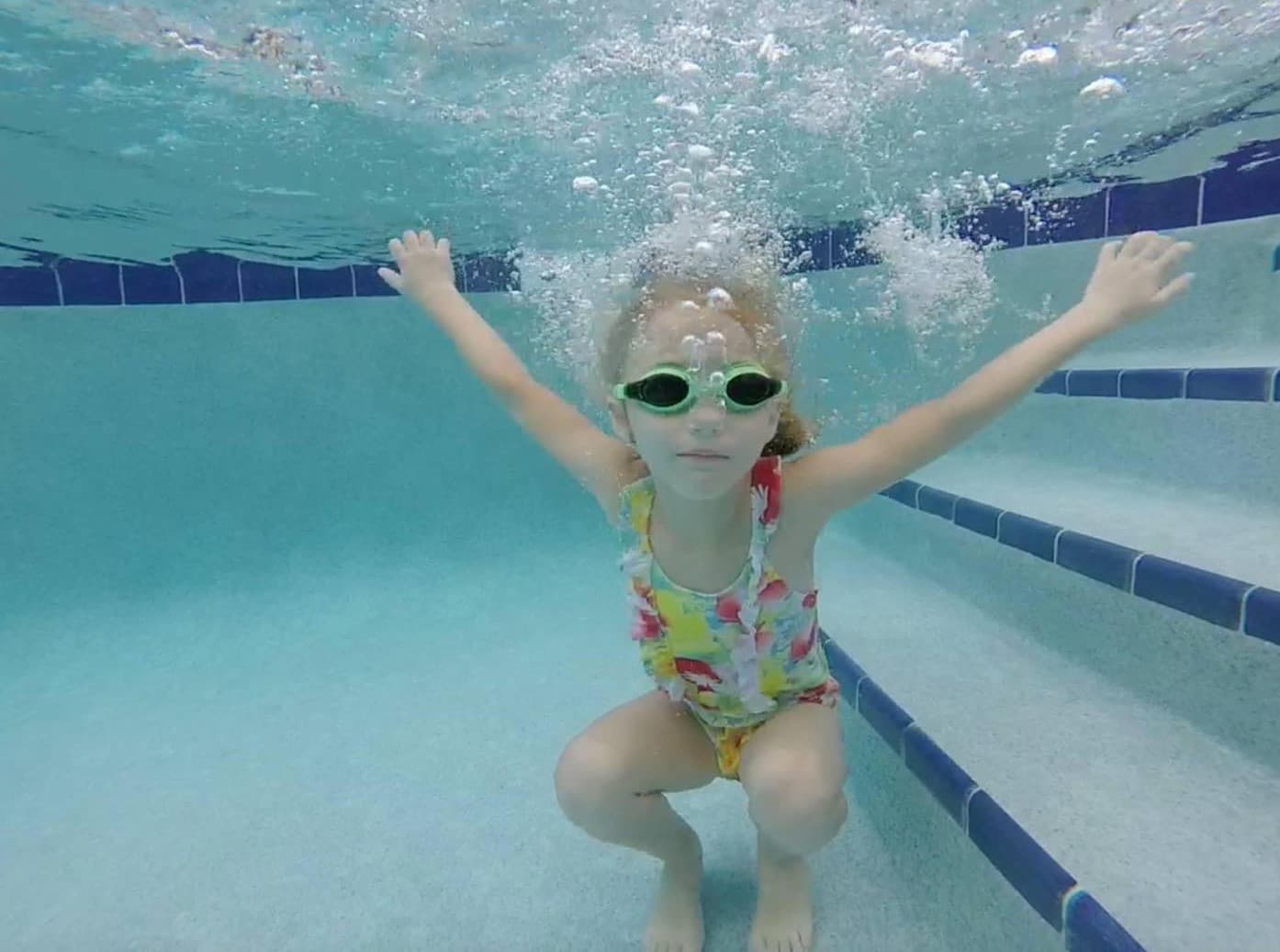 a girl in a swimsuit in a pool