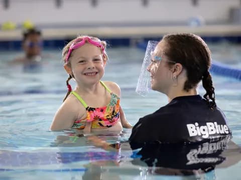 a person and a child in a pool