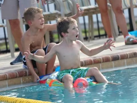 a couple of boys in a pool