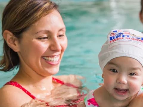 a person and a baby in a pool