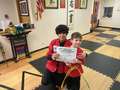 a couple of boys holding a sign