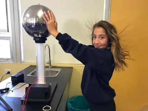 a person holding a silver trophy
