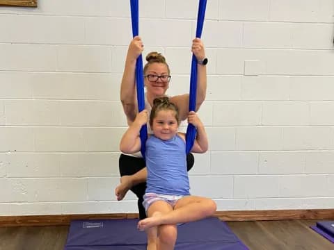 a woman and a child on a swing
