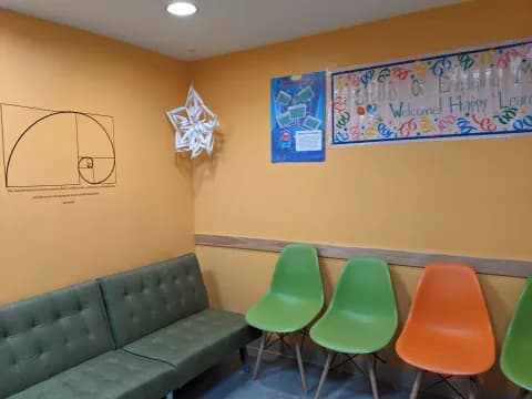 a classroom with green chairs