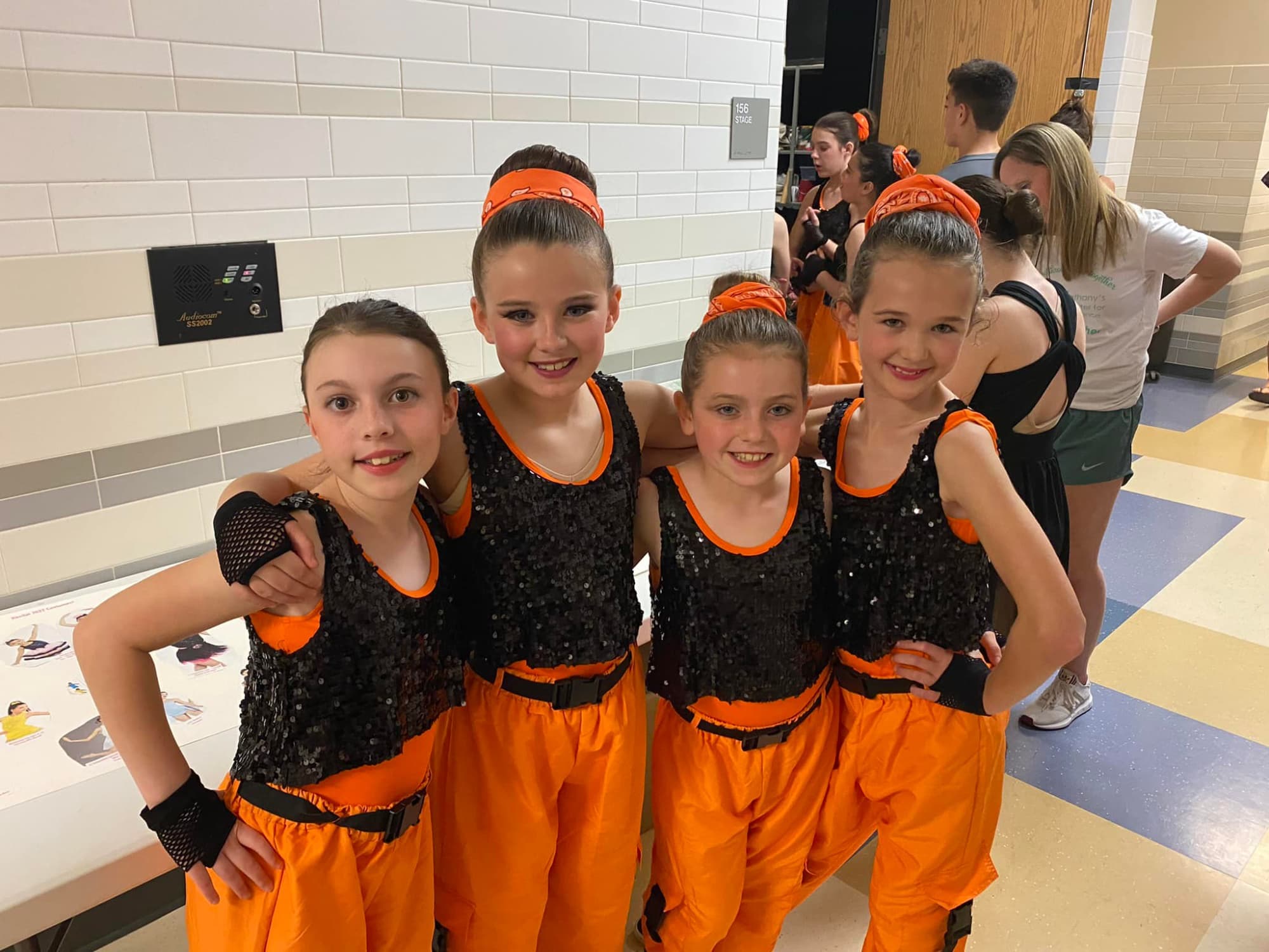 a group of girls in orange jumpsuits