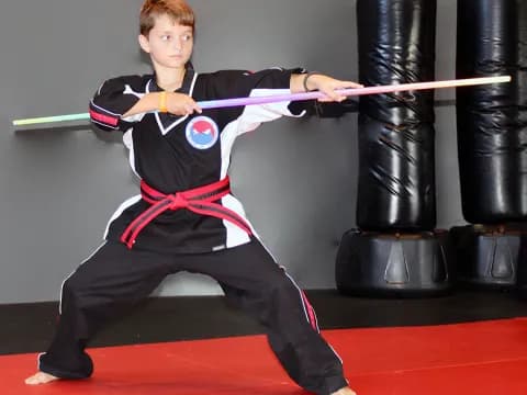 a boy in a martial arts uniform