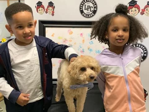 a boy and girl posing with a dog