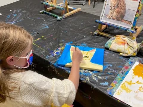 a girl painting on a table