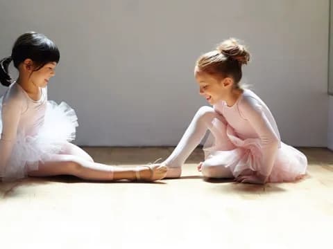 two girls sitting on the floor