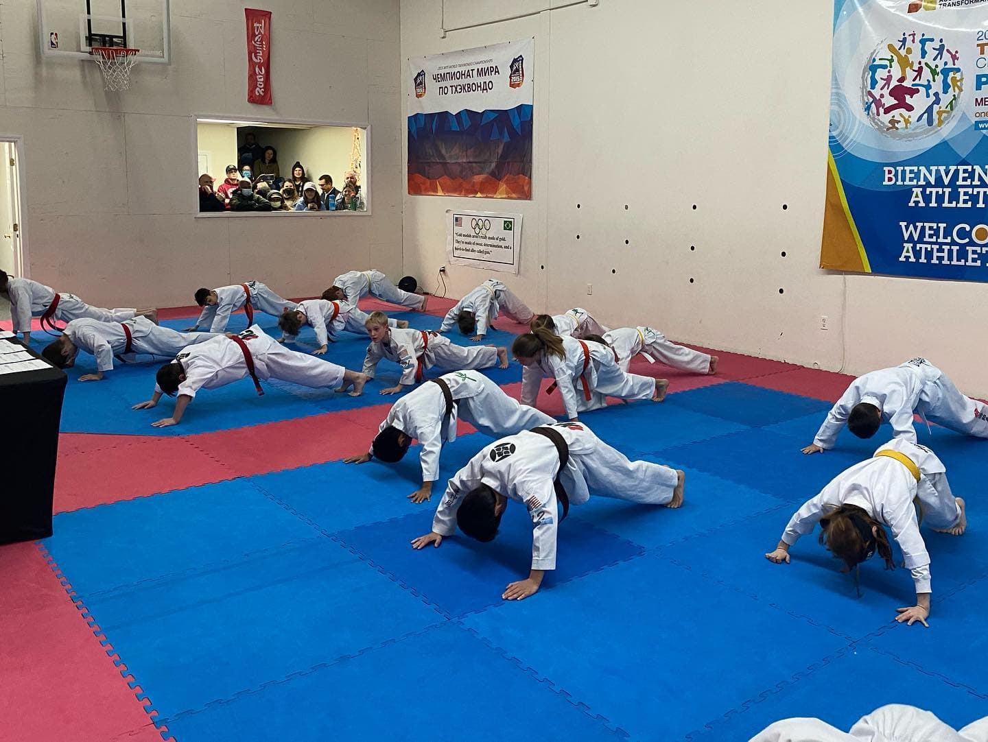 a group of people in karate uniforms