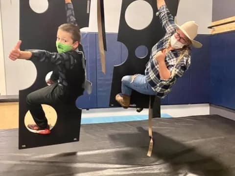 a person and a boy on a swing set
