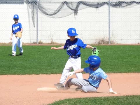 kids playing baseball on a field