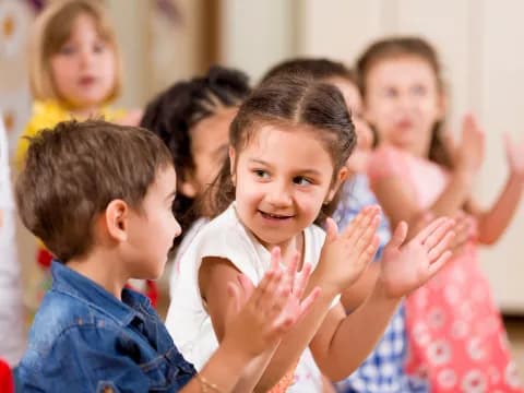a group of children clapping