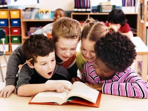 a group of children reading a book