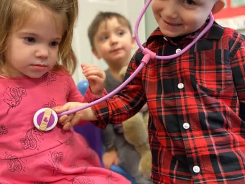 a group of children holding a toy