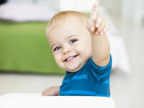 a baby with a thumbs up