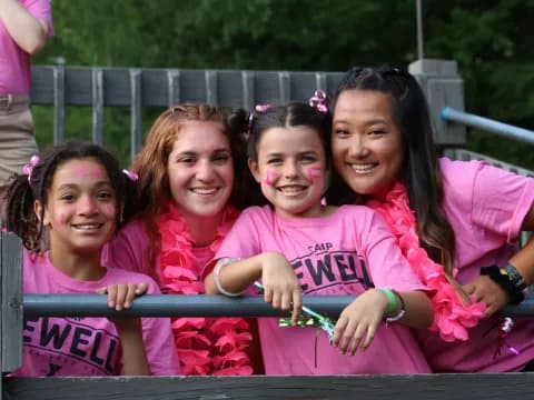 a group of girls in pink shirts