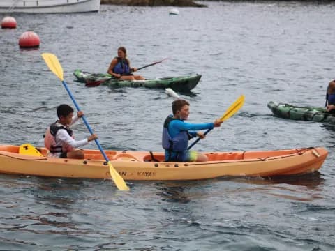 a group of people in kayaks