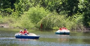 a group of people on boats in a river