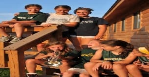 a group of people sitting on a picnic table
