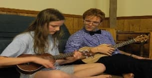 a man and a woman playing a guitar