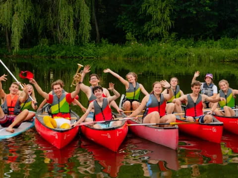 a group of people in canoes