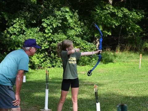 a man and a child shooting bows
