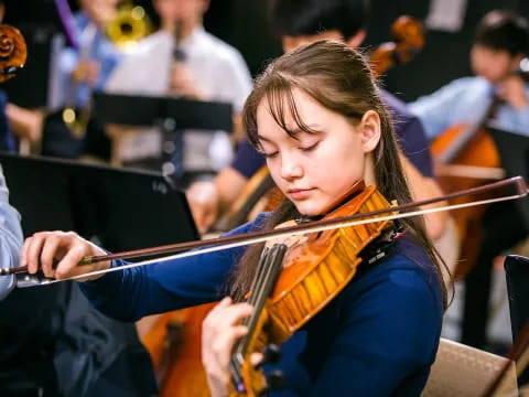 a girl playing a violin