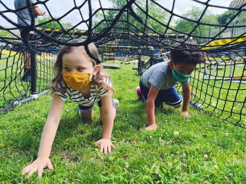 children playing in the grass