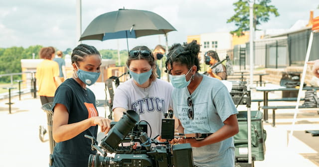 a group of people wearing masks
