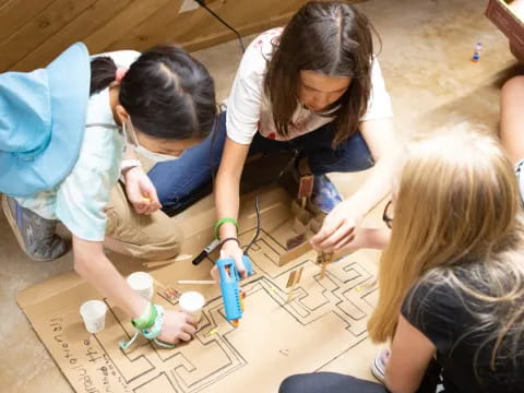 a group of girls doing crafts