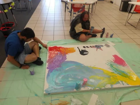 a couple of men painting