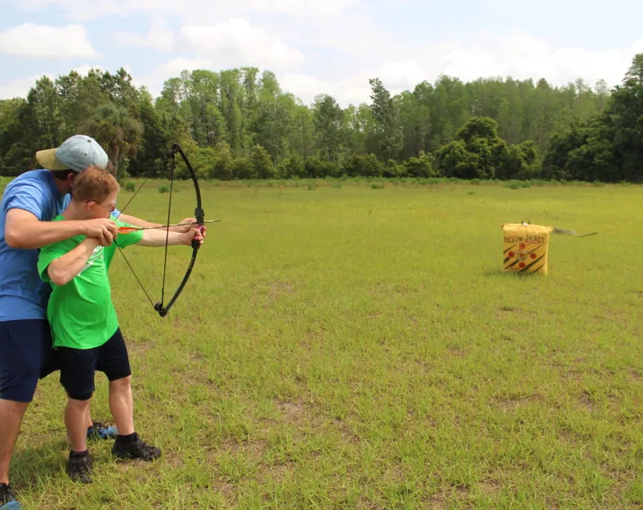 a couple of people shooting bows