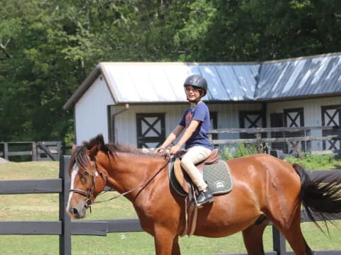 a boy riding a horse