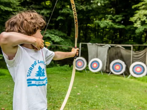 a boy holding a bow and arrow