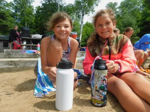 two girls sitting on a beach