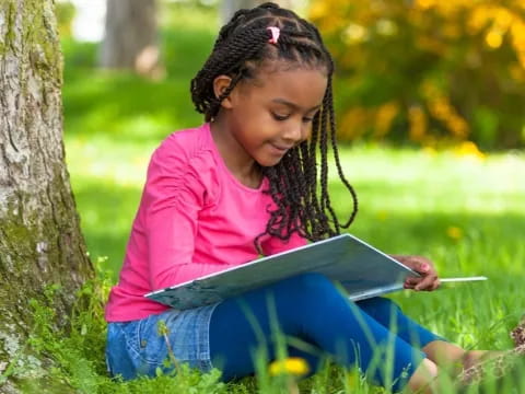 a young girl reading a book