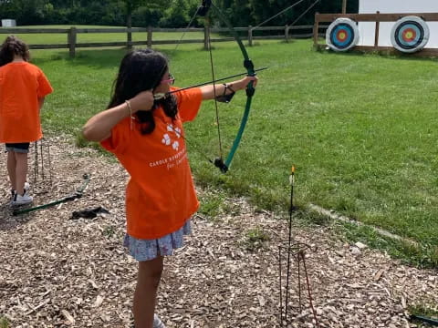 a girl holding a bow and arrow
