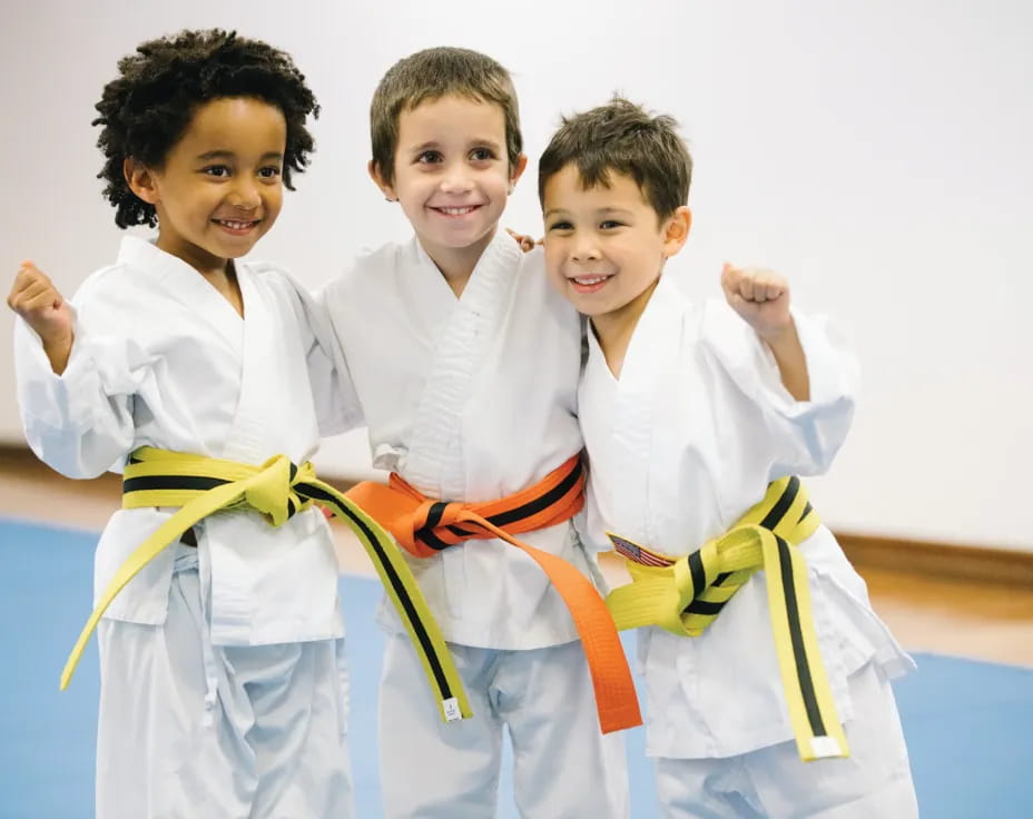 a group of kids in karate uniforms