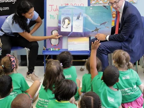 a man and woman teaching children