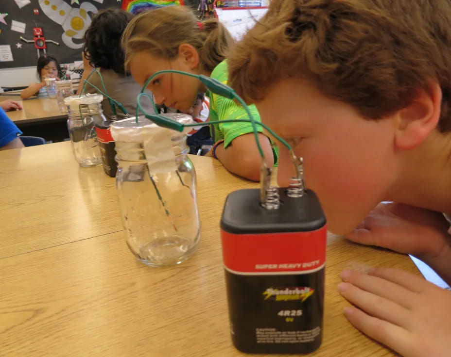 a boy drinking from a bottle