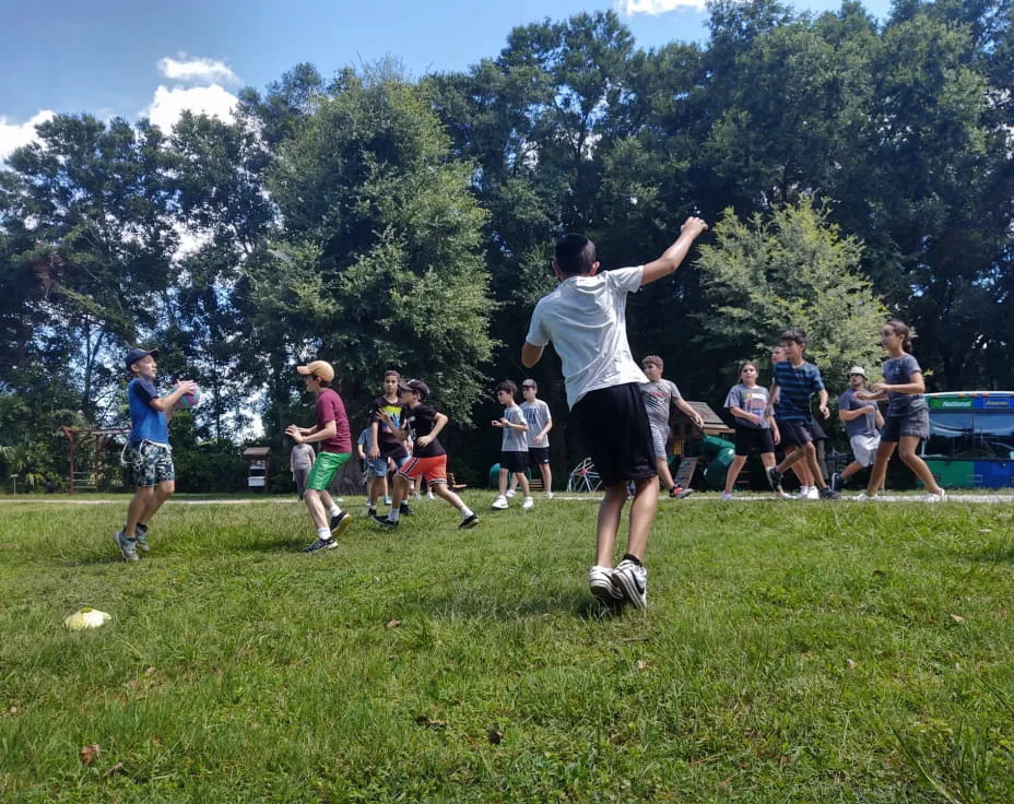 a group of people playing frisbee