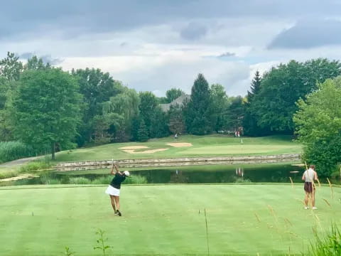 a couple of people playing golf