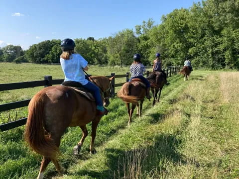 a group of people riding horses