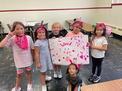 a group of girls holding a sign