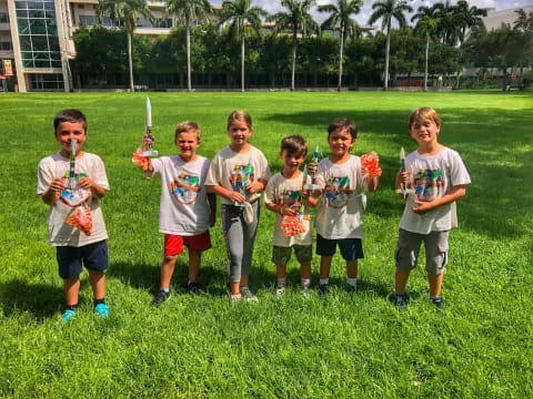 a group of boys holding trophies