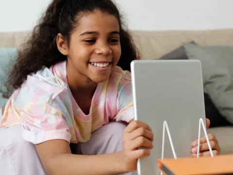 a young girl using a laptop