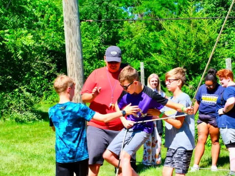 a group of people holding a rope